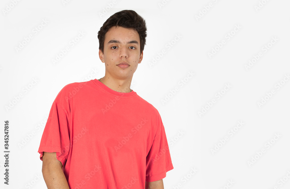 Handsome Young Male Model Wearing a Salmon Color Tee Shirt Against a White Backdrop Handsome Young Male Model Wearing a Salmon Color Tee Shirt Against a White Backdrop