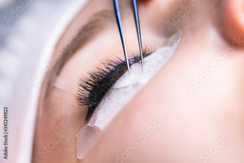 Eyelash Extension Procedure. Woman Eye with Long Eyelashes. Lashes, close up, macro, selective focus. © satura_