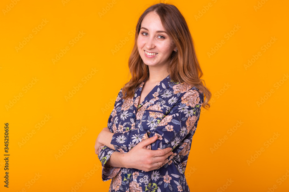 Fashion portrait pretty cool girl in home wear pajama having fun over colorful yellow background. Fashion portrait pretty cool girl in home wear pajama having fun over colorful yellow background.