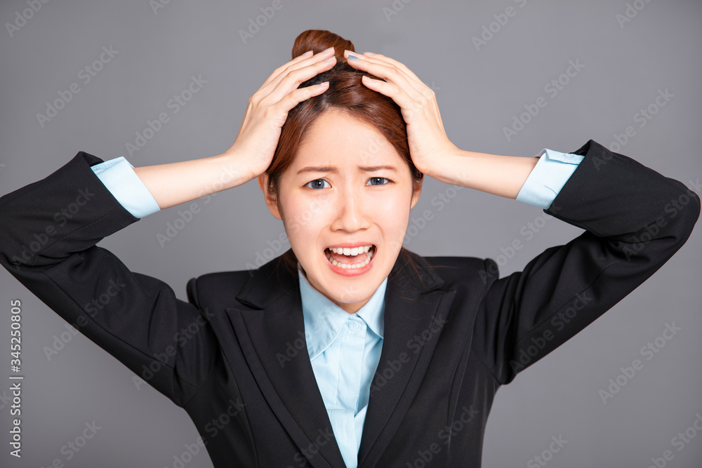 young business woman is going crazy pulling her hair in frustration young business woman is going crazy pulling her hair in frustration