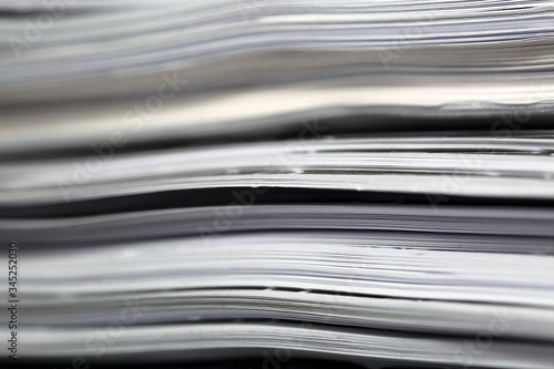 Stack of sheets of paper documents in soft focus close up macro