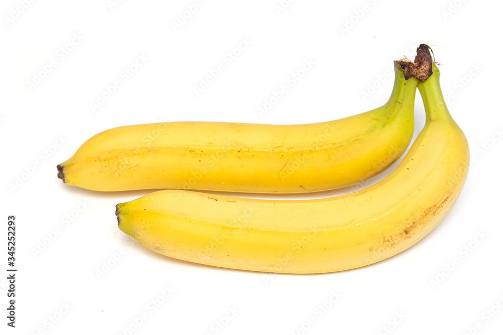 A ripe yellow banana is isolated on a white background.