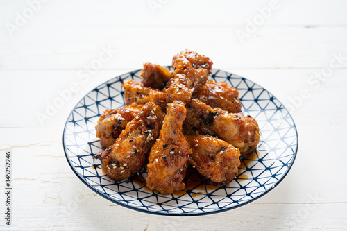 Sour-sweet baked chicken wings sesame and  teriyaki sauce.