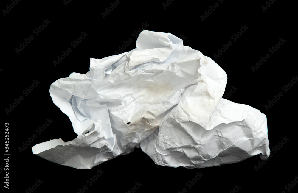 A piece of crumpled white paper on a black background. A piece of crumpled white paper on a black background.