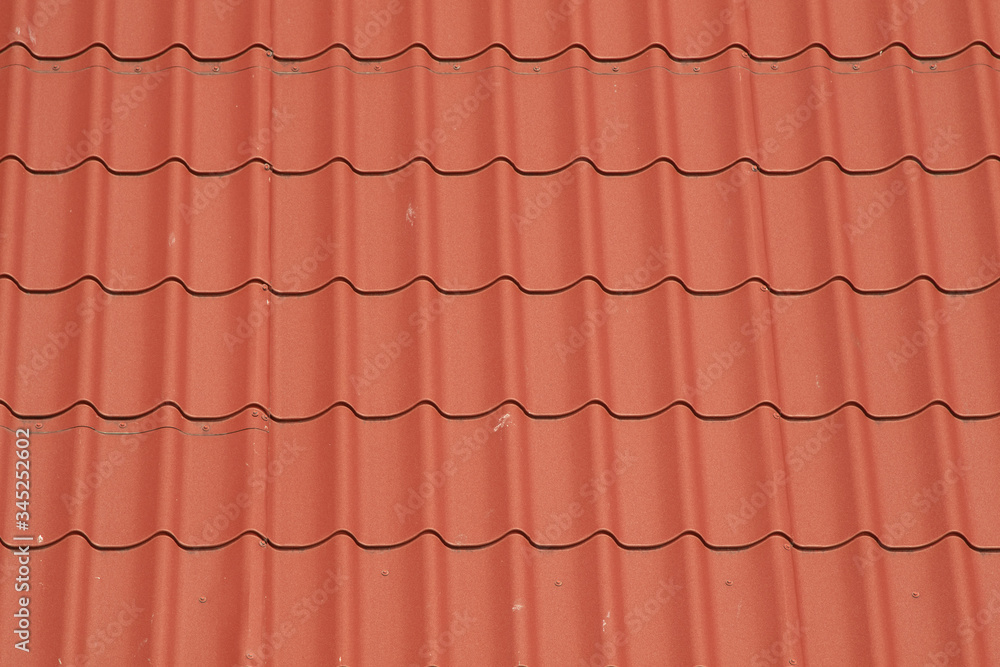 The texture of metal tiles on the roof of the house. The texture of metal tiles on the roof of the house.