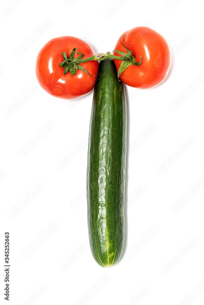 Green long cucumber and red tomatoes on a white background. Green long cucumber and red tomatoes on a white background.