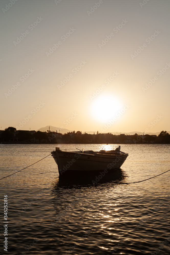 Fototapeta premium fishing boat at sunset, boat on the water, boat on the sea