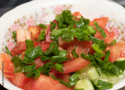 Salad, tomatoes, cucumbers, green onions, close-up.