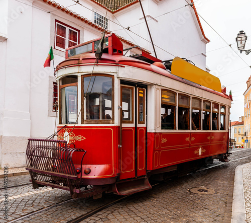 Typical old tram crowded with tourists crisscrossing Lisbon in Portugal