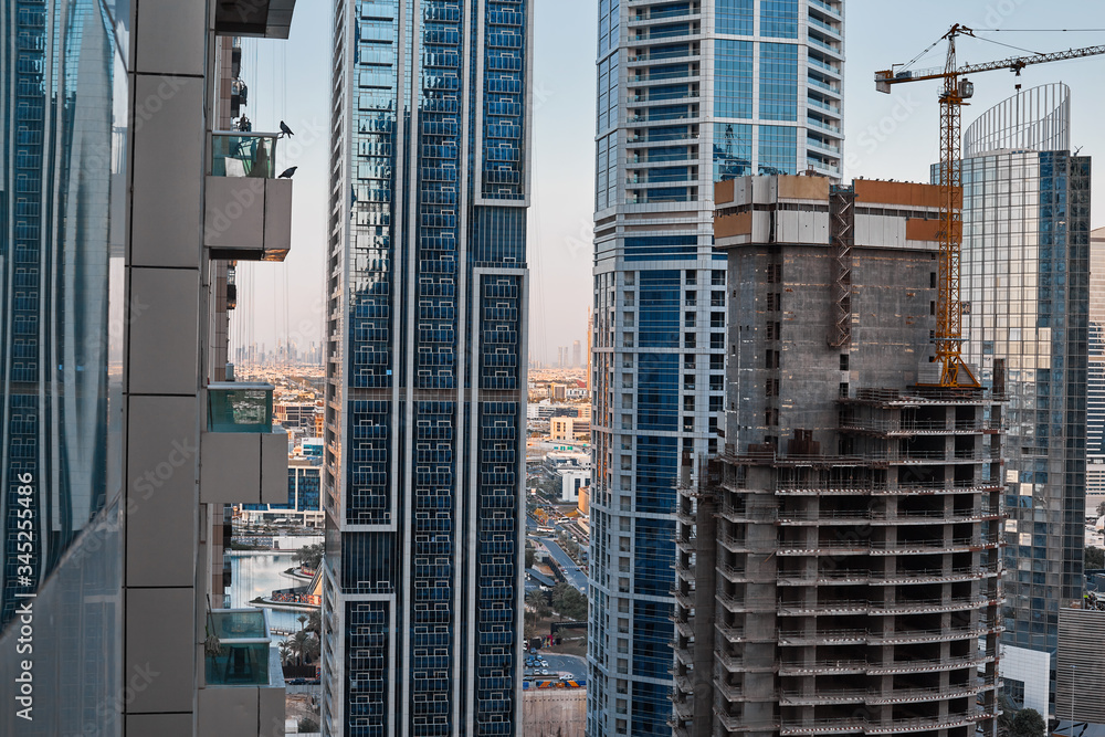 Construction of a new building in Dubai against the backdrop of modern skyscrapers