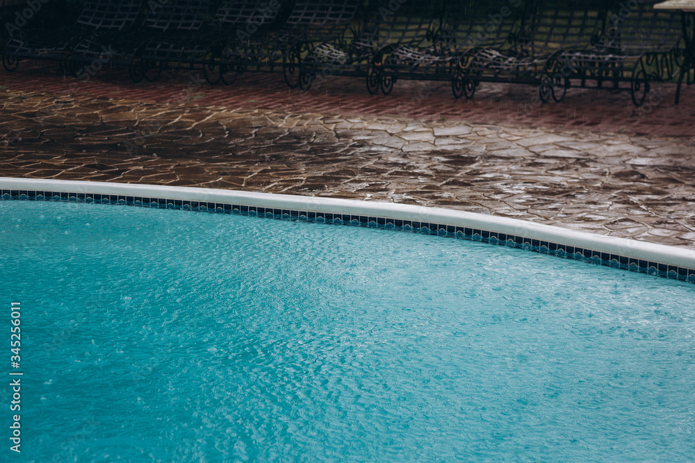 turquoise water in the rain of an empty pool