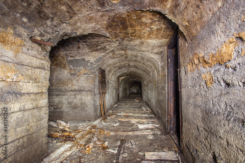 Fototapeta Naklejka Na Ścianę i Meble -  Underground abandoned iron ore mine tunnel with concrete timbering