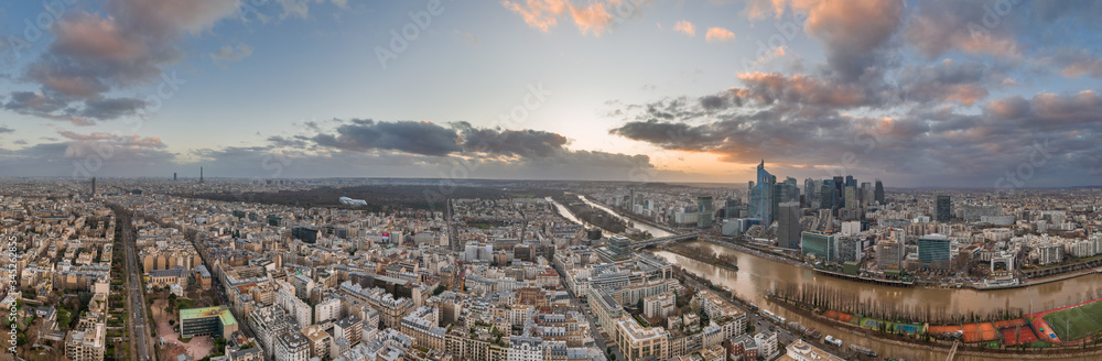 Panoramic aerial drone shot of Neuilly Levallois and la defense skyscraper complex with Eiffel tower la seine during sunset hour in Paris