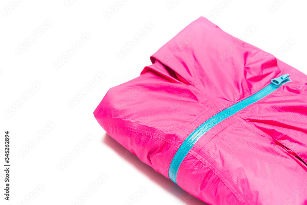 Folded pink zipper windbreaker jacket, rain proof jacket hoodie. Track jacket sport shiny nylon full zip isolated on white. Folded clothes. Folded pink zipper windbreaker jacket, rain proof jacket hoodie. Track jacket sport shiny nylon full zip isolated on white. Folded clothes.