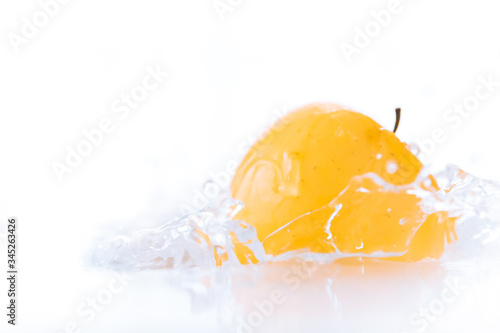 Golden apple delicious fall into the refreshing freeze water splash