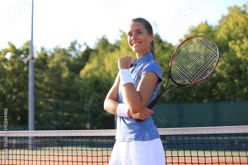 Woman tennis player showing yes gesture after winning point, successful game. © ty