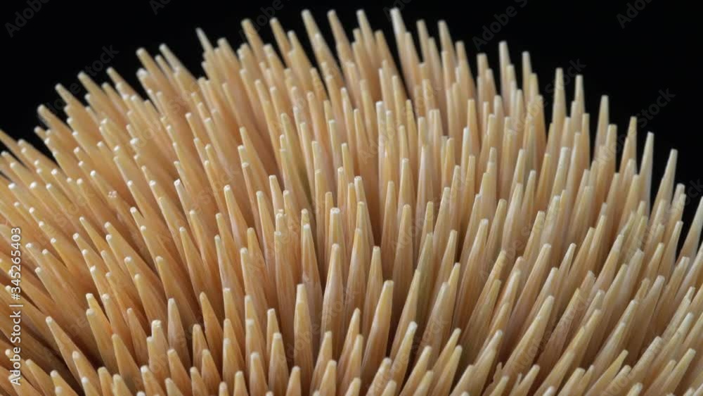Macro close up of wooden bamboo toothpicks, slow motion rotation from the side. Concept of personal teeth hygiene or oral tooth care after meal. Caries prevention. Dental healthcare. Macro close up of wooden bamboo toothpicks, slow motion rotation from the side. Concept of personal teeth hygiene or oral tooth care after meal. Caries prevention. Dental healthcare.