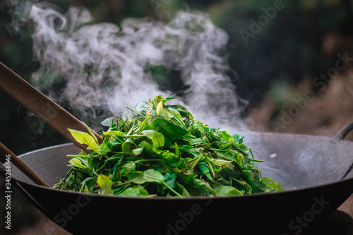 Traditional tea roasting using sticks and hands