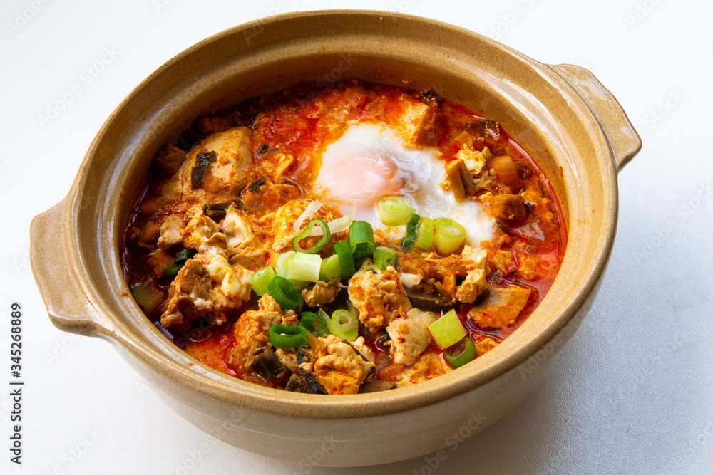Korean spicy silken tofu stew which is called Sundubu Jjigae Korean spicy silken tofu stew which is called Sundubu Jjigae
