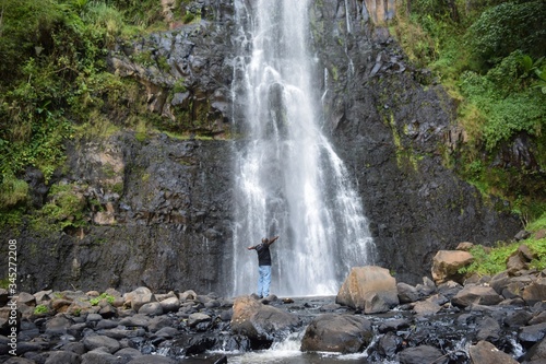 A hiker against a scenic waterfall in rural Kenya  Aberdare Rnges