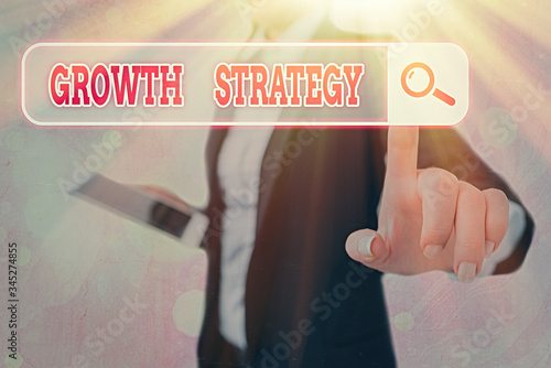 Writing note showing Growth Strategy. Business concept for Strategy aimed at winning larger market share in shortterm photo