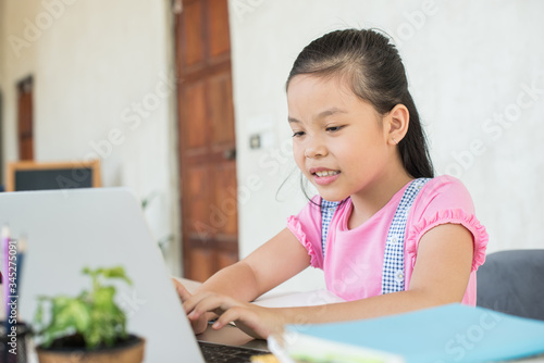 asian girl student online learning study online with video call teacher. social distance during quarantine, self-isolation, online education concept, homeschool, stay at home entertainment.