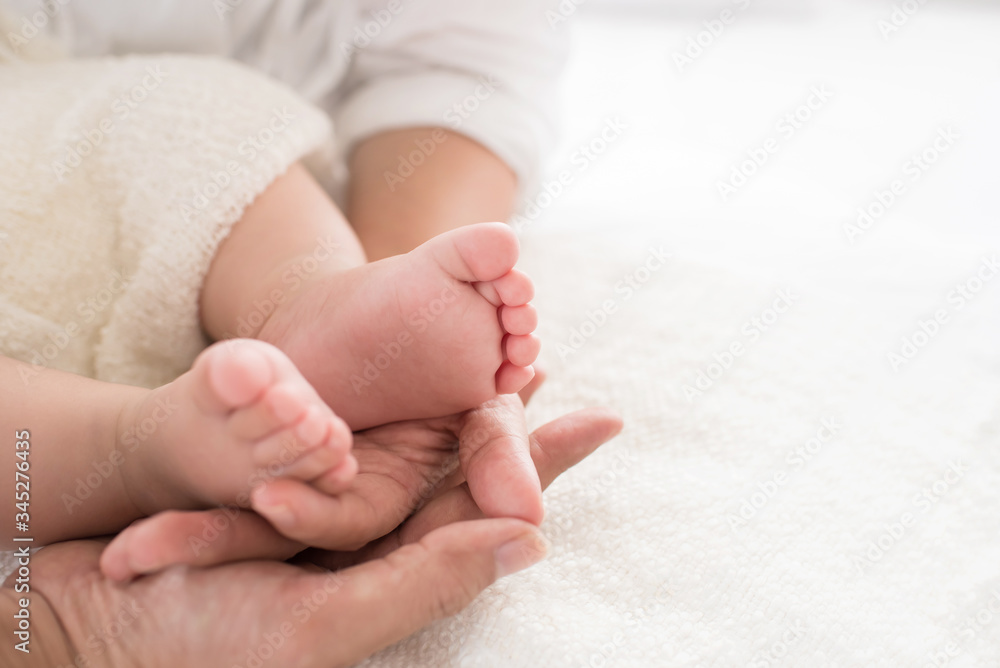 closeup newborn baby feet while the mother is carrying in home. baby feet in mother hands. mom and her Child. happy family concept. beautiful conceptual image of maternity. closeup newborn baby feet while the mother is carrying in home. baby feet in mother hands. mom and her Child. happy family concept. beautiful conceptual image of maternity.