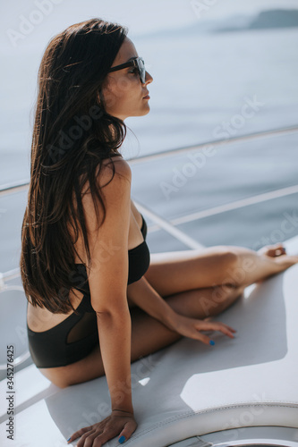 Young woman in swimwear and...