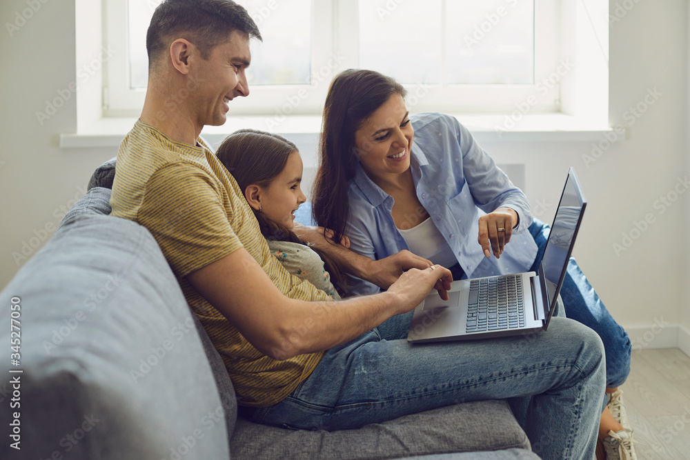 Happy family uses online laptop at home Happy family uses online laptop at home