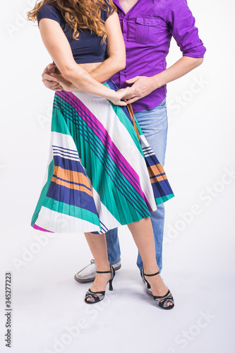 Close-up of couple dancing social dance. Kizomba or bachata or semba or taraxia , on white background. Social dance concept. photo