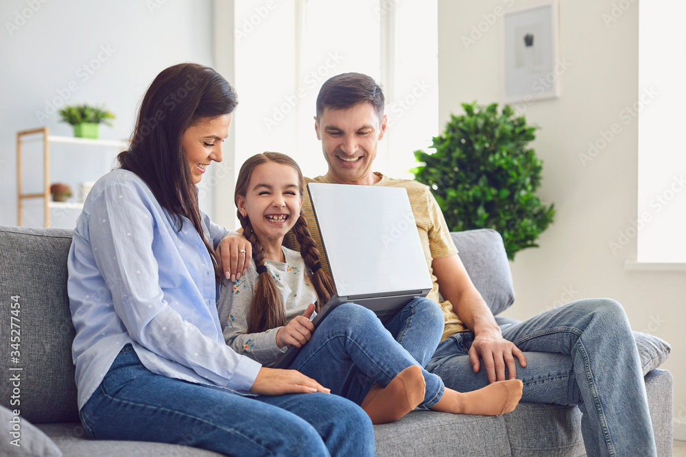 Happy family laptop online. Parents and a kid girl smiling at a laptop at their leisure in a weekend at home. Happy family laptop online. Parents and a kid girl smiling at a laptop at their leisure in a weekend at home.