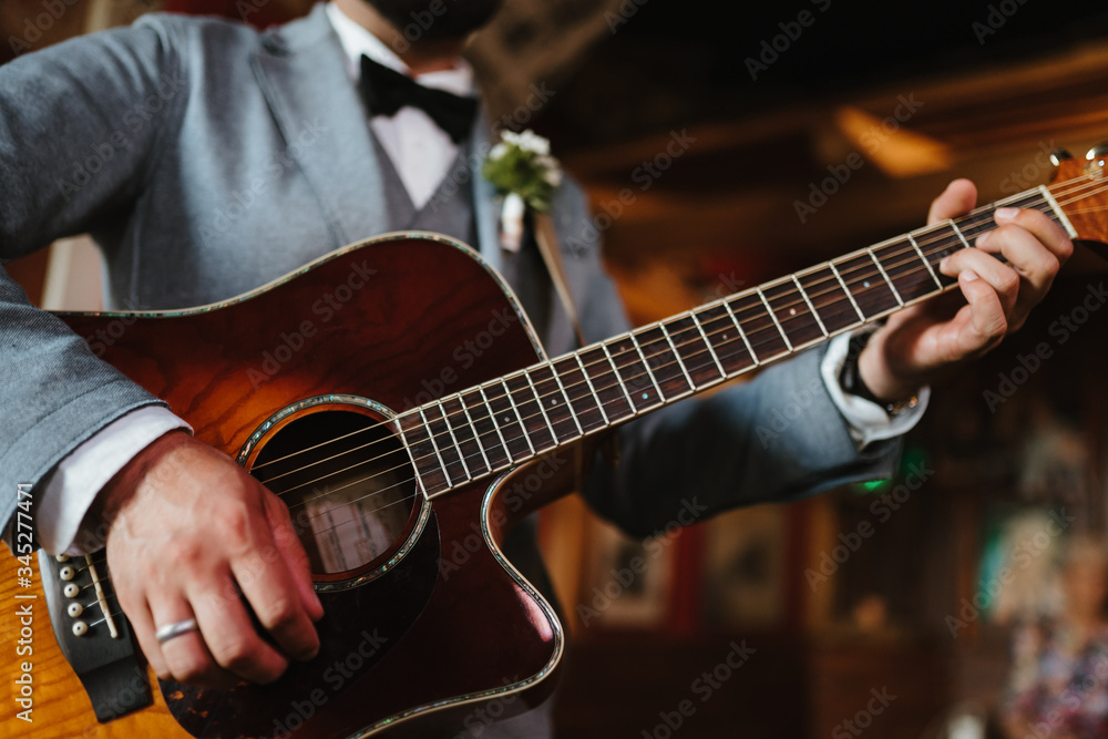 photo of a man playing the guitar