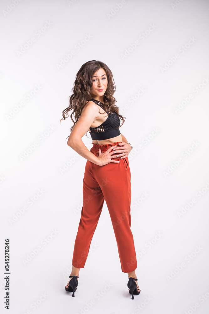 Latina dance, strip dance, contemporary and bachata lady concept - Woman dancing improvisation and moving her long hair on a white background. Latina dance, strip dance, contemporary and bachata lady concept - Woman dancing improvisation and moving her long hair on a white background.