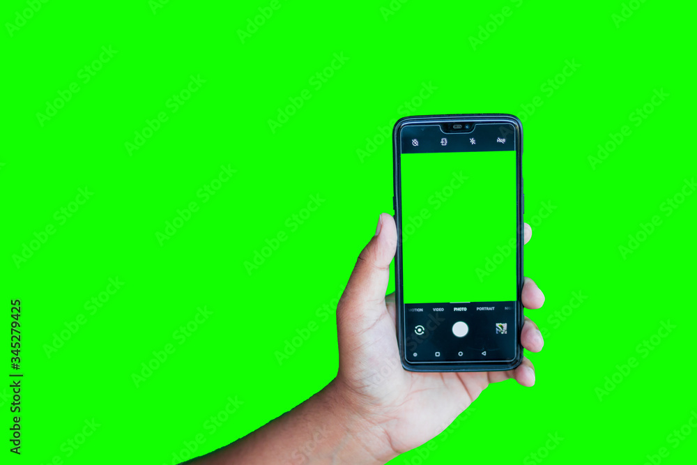 Man holding phone with camera interface against the green screen background Man holding phone with camera interface against the green screen background