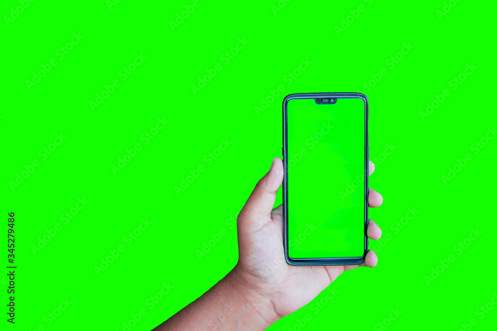 Man holding phone with chroma key display against the green screen  background Stock Photo | Adobe Stock