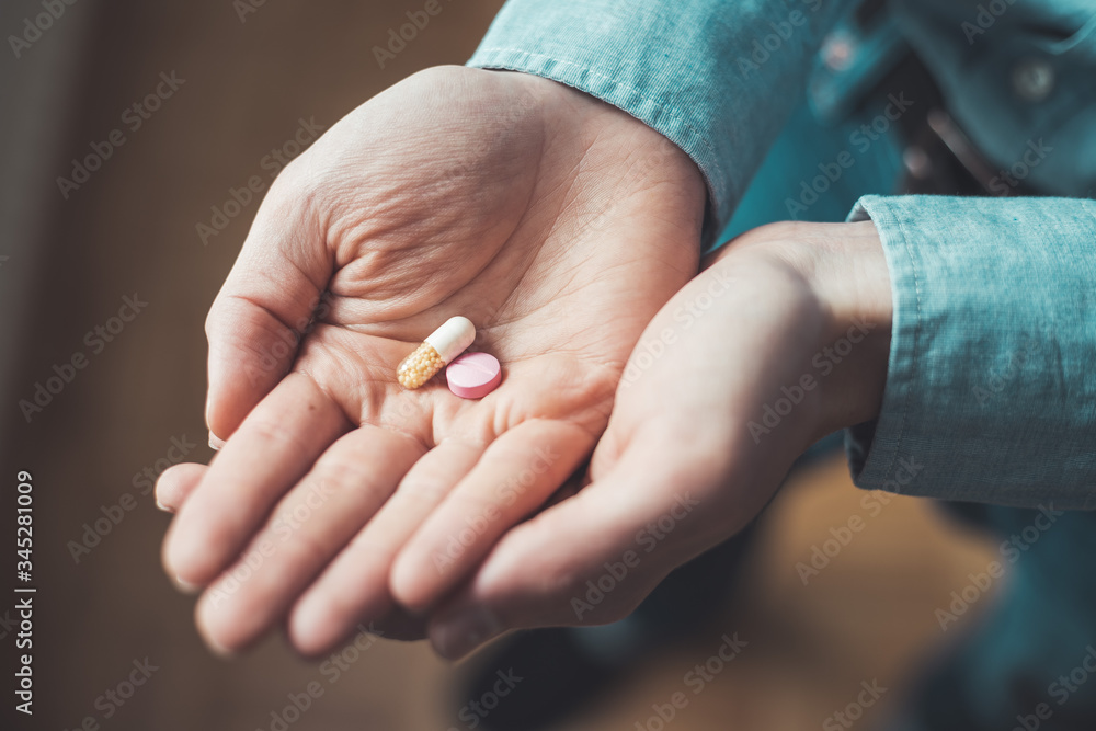Medicament or cure concept. Close up of male hand with pills. Medicament or cure concept. Close up of male hand with pills.