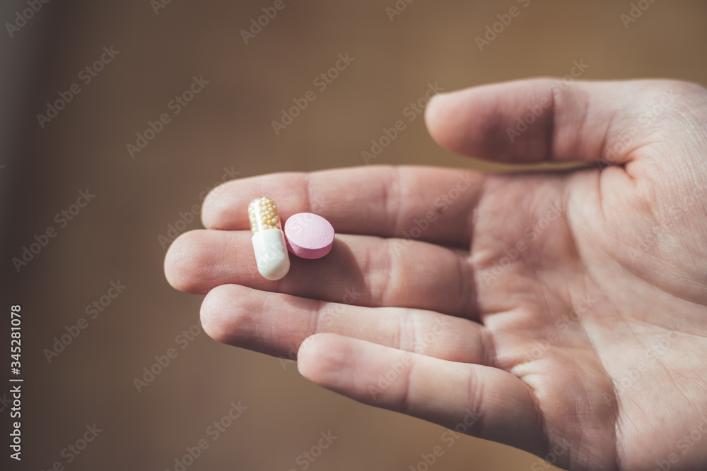 Medicament or cure concept. Close up of male hand with pills. Medicament or cure concept. Close up of male hand with pills.