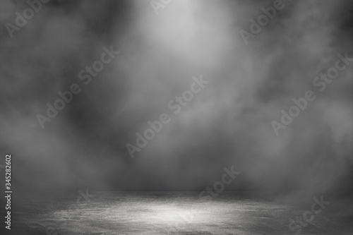 Empty space studio dark room with spot lighting and fog in black background. 