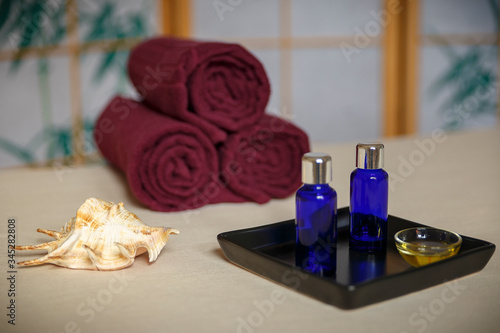 wellness spa decoration with oil bottle  seashell and towels