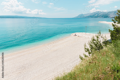 2020 tourism crisis. empty large beach with view to mountain in croatia in summer