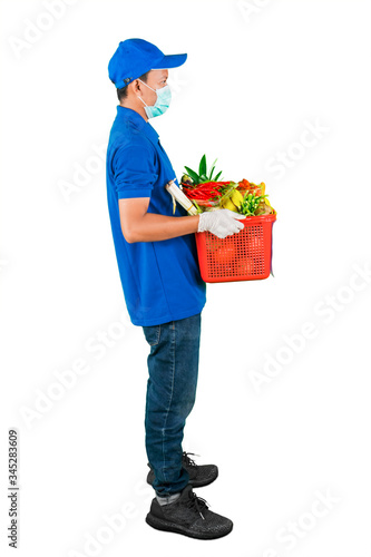 Side view of man holding basket full of groceries © Creativa Images