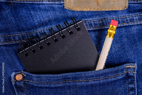Jeans back pocket with notepad and pencil