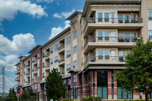 Modern brick and stucco condo buildings with balconies and garages