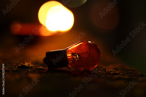 A abstractive photography of a bulb reflecting light of lighting in low light. photo