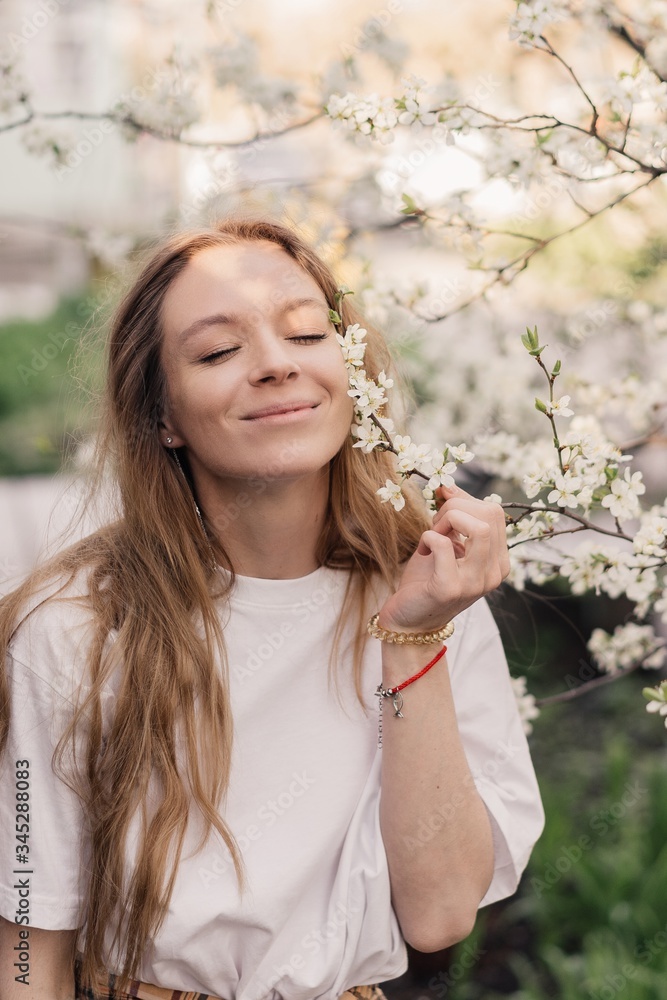 Closeness to nature. happy beautiful girl in blooming gardens. Natural beauty