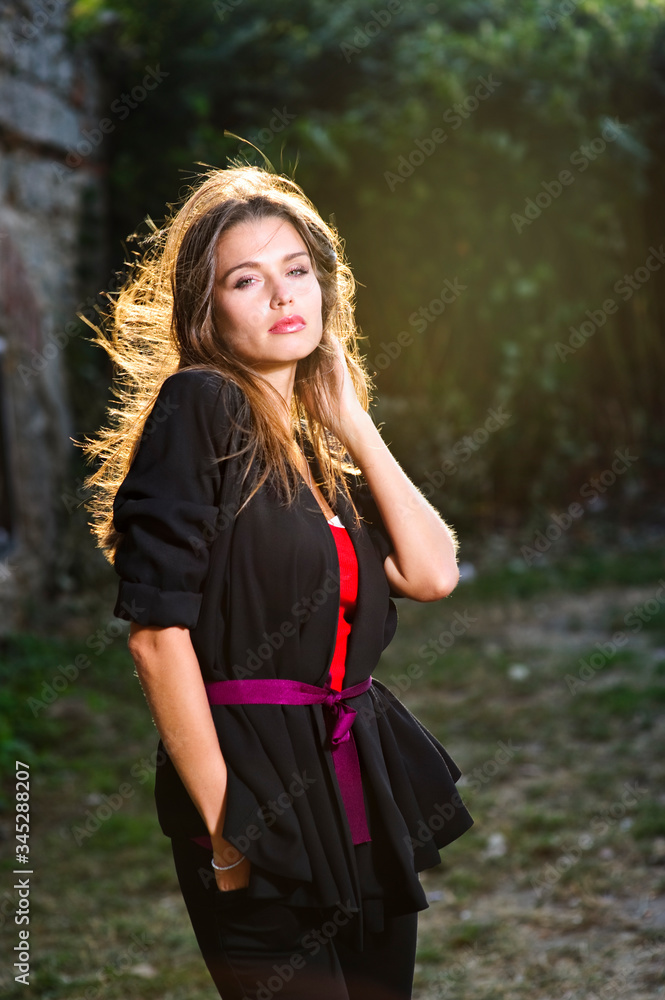 Yang beautiful European woman poses outdoor.