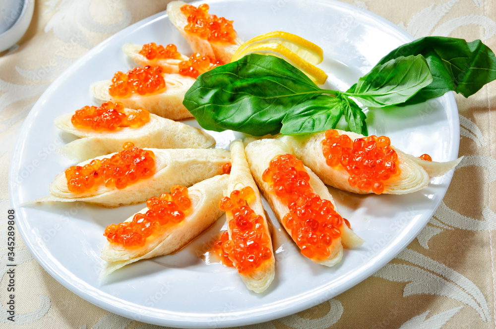 Traditional Russian pancakes with red caviar. Traditional Russian pancakes with red caviar.
