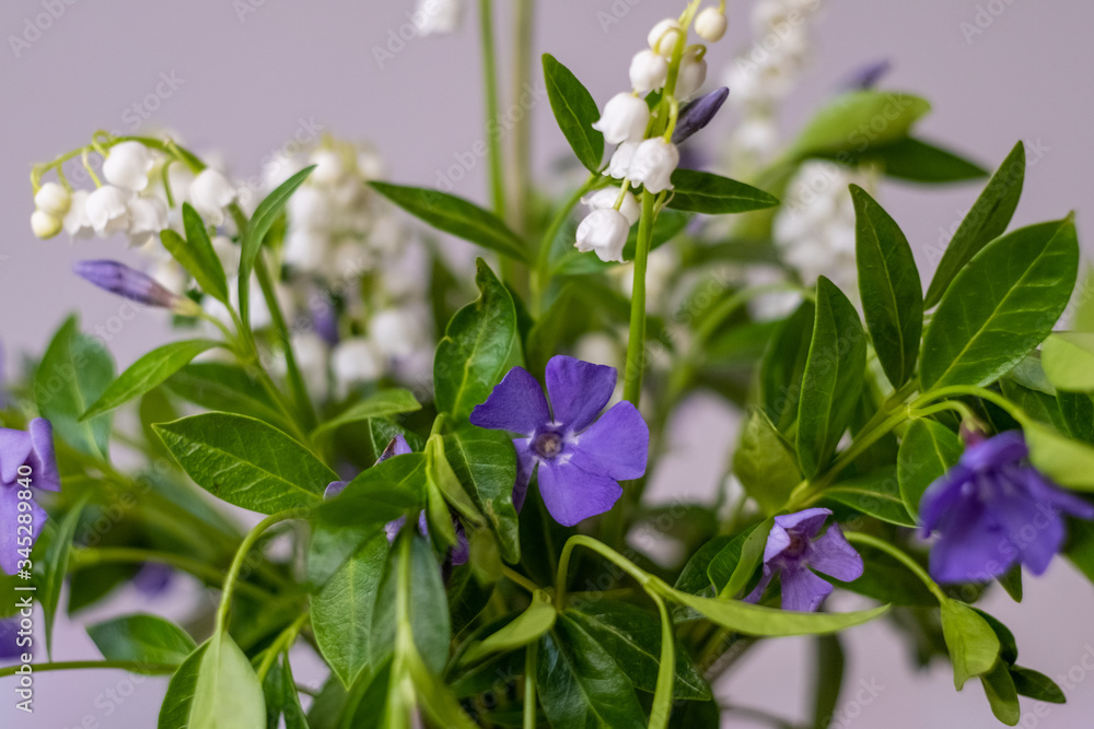 bouquet of spring flowers with lilies of the valley and periwinkle Selective focus bouquet of spring flowers with lilies of the valley and periwinkle Selective focus
