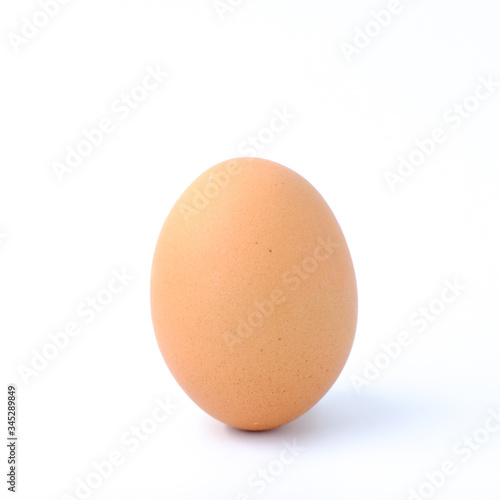 Close-up top view of organic Single raw eggs in egg box on white background with copy space for your text, healthy eating concept.