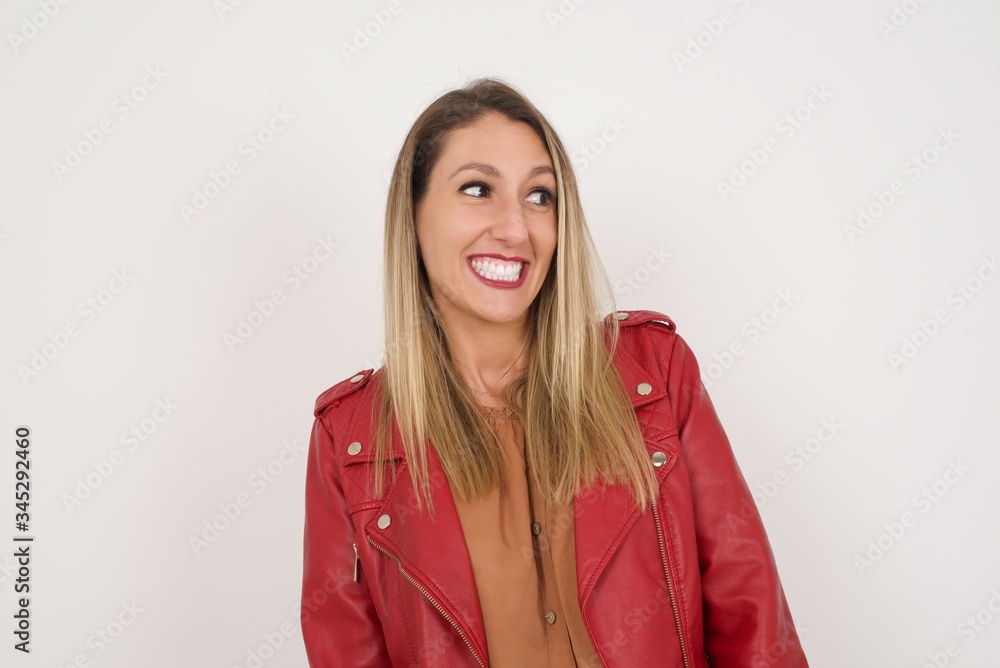 Oops! Portrait of female with specific appearance clenches teeth and looks confusedly aside, realises her bad mistake, poses against copy area for your advertising or promotional background. Oops! Portrait of female with specific appearance clenches teeth and looks confusedly aside, realises her bad mistake, poses against copy area for your advertising or promotional background.